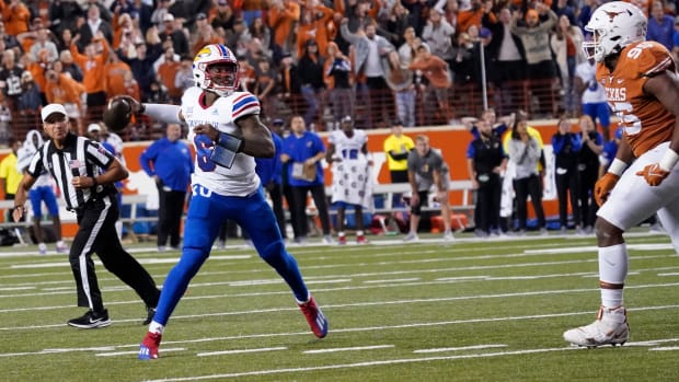 Nov 13, 2021; Austin, Texas, USA; Kansas Jayhawks quarterback Jalon Daniels (6) looks for a receiver to complete the game winning two point conversion against the Texas Longhorns in overtime at Darrell K Royal-Texas Memorial Stadium. Mandatory Credit: Scott Wachter-USA TODAY Sports